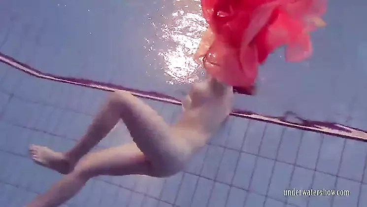 redhead dancing in the pool