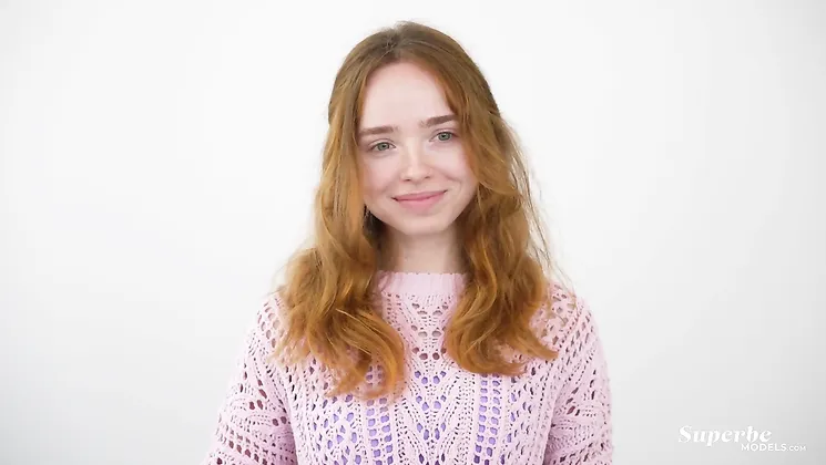 Watch this hot redhead in lingerie strip down and get wild on camera